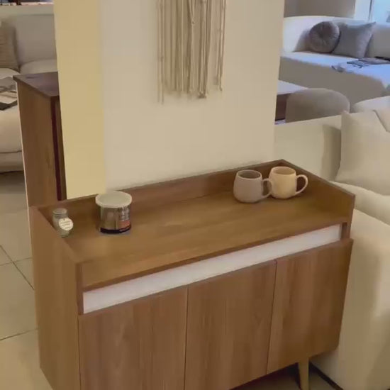 Oslo coffee cabinet with cups on its top in a home setting